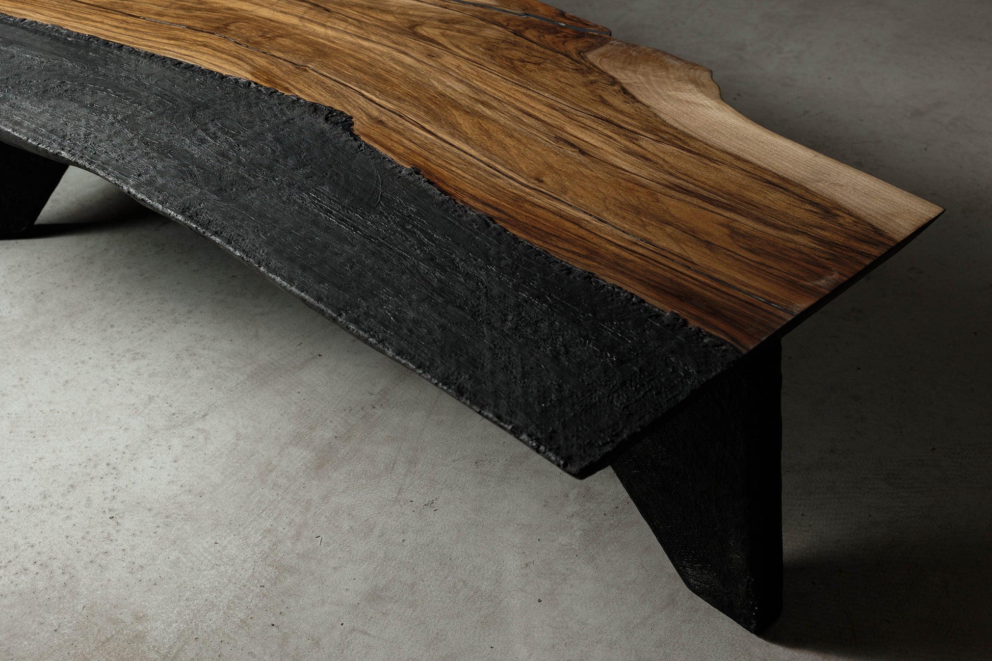 Brutalist Coffee Table With Japandi Influences EM106 Part Of 18Brut Collection | Close-up shot from above showcasing the black texture of the fibreglass and live edge shape of the walnut slab. 