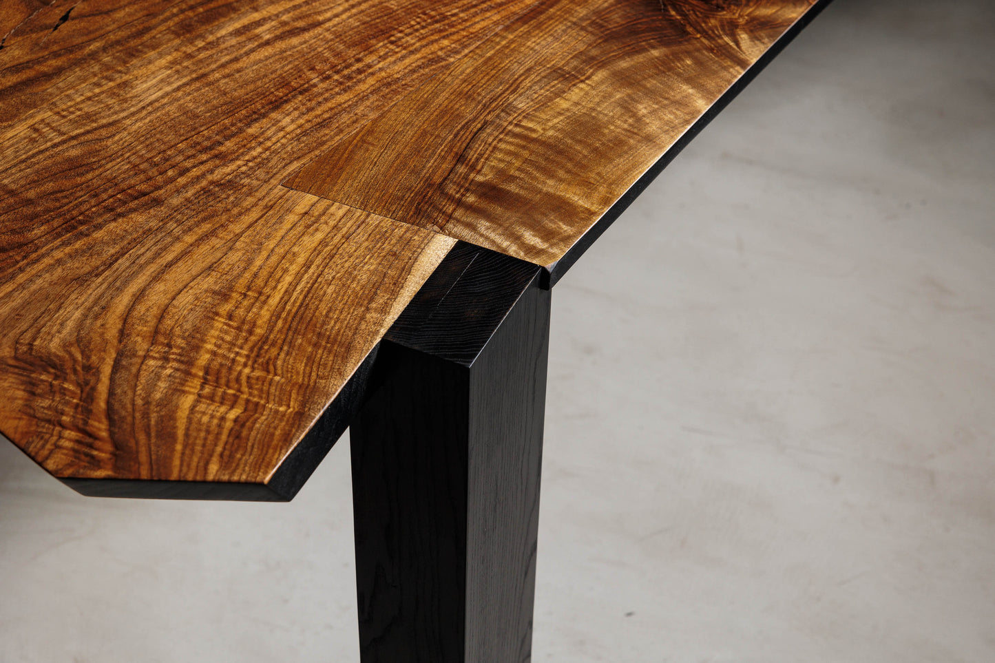 EM201 Of 18Brut Collection | Close-up image showing the joinery details between the walnut top and ash leg. 