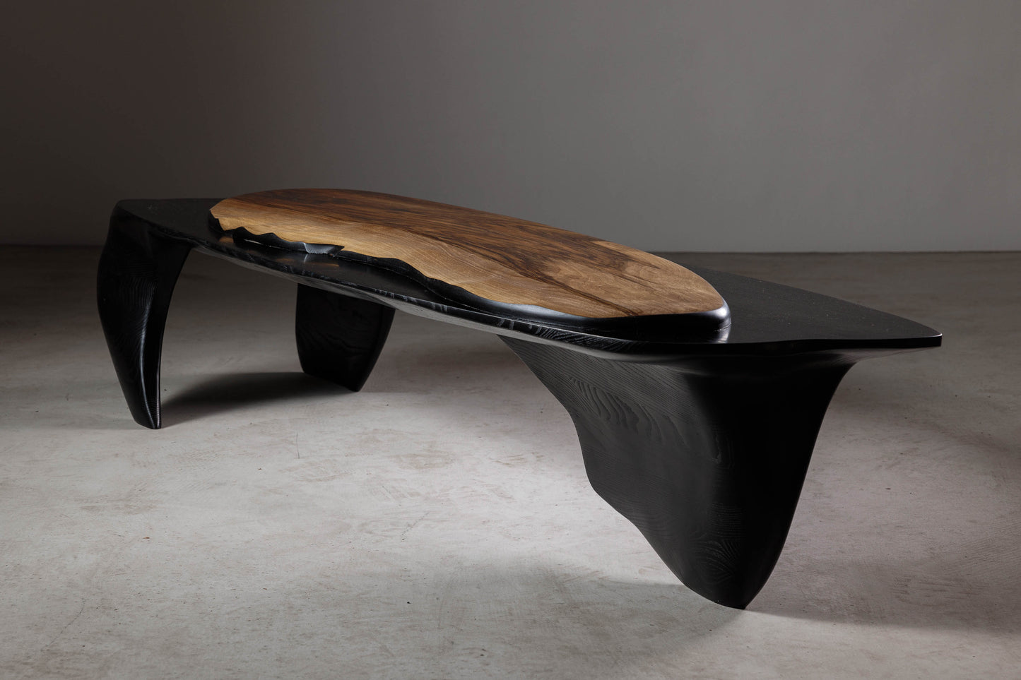 Sculptural Walnut Coffee Table EM110 Part Of Erosio Collection | Perspective image from the front showing the hand-carved ripples in the walnut slab.